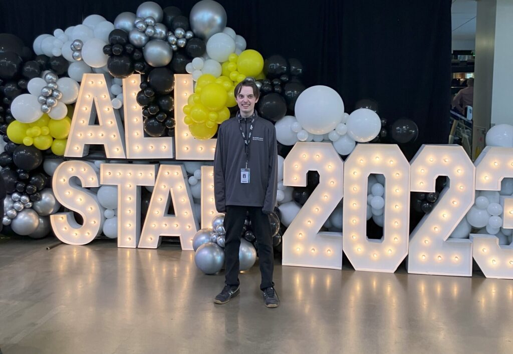 Photo of James Knight standing in front of All Star 2023 sign.